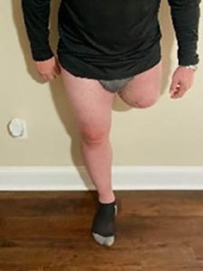 Male stands against wall with leg amputation