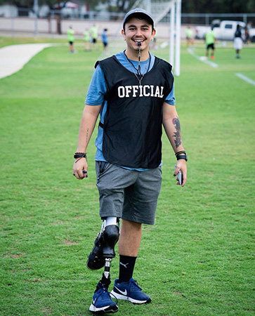 Soccer official with leg prosthetic on field